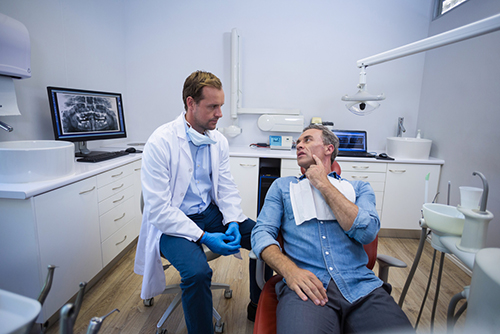 Dentist talking to patient