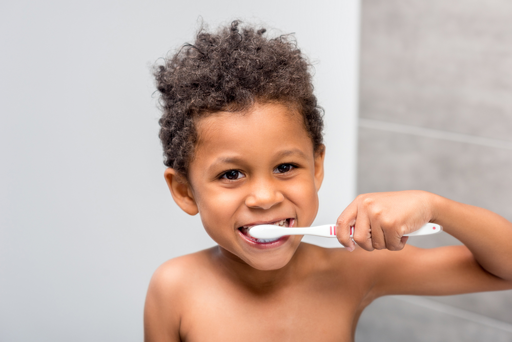 Kid brushing his teeth