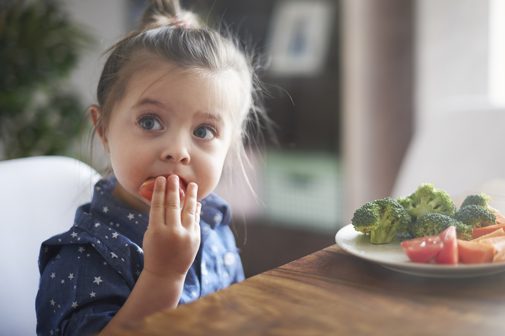 a child eating vegetables