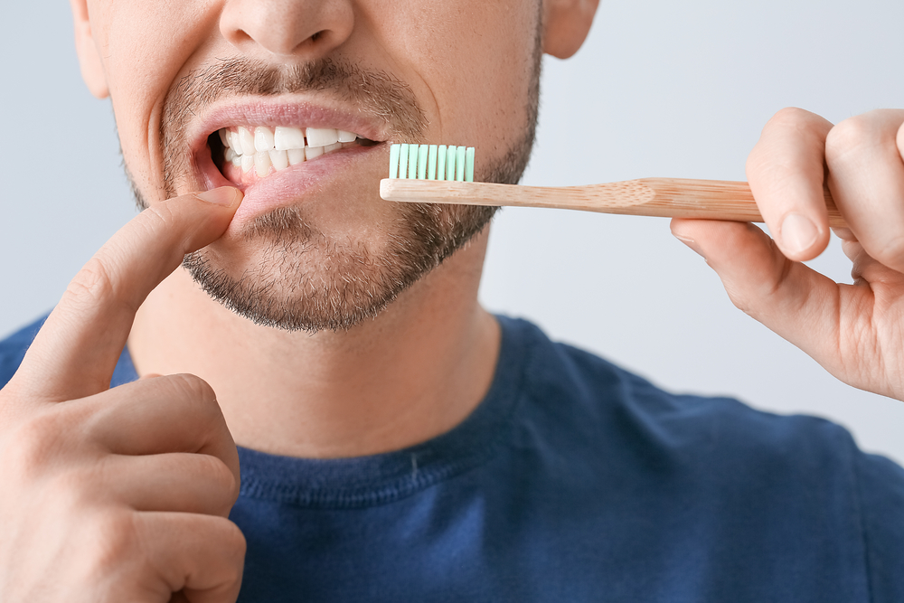 Man brush teeth and gums